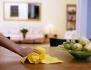 Female hand wiping dining table